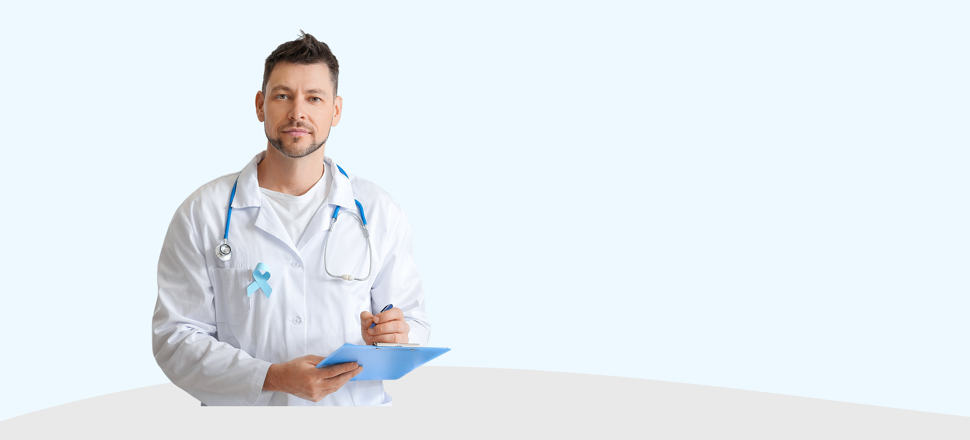 male doctor writing on clipboard