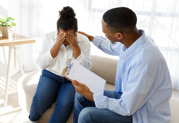 Man comforting a sad woman