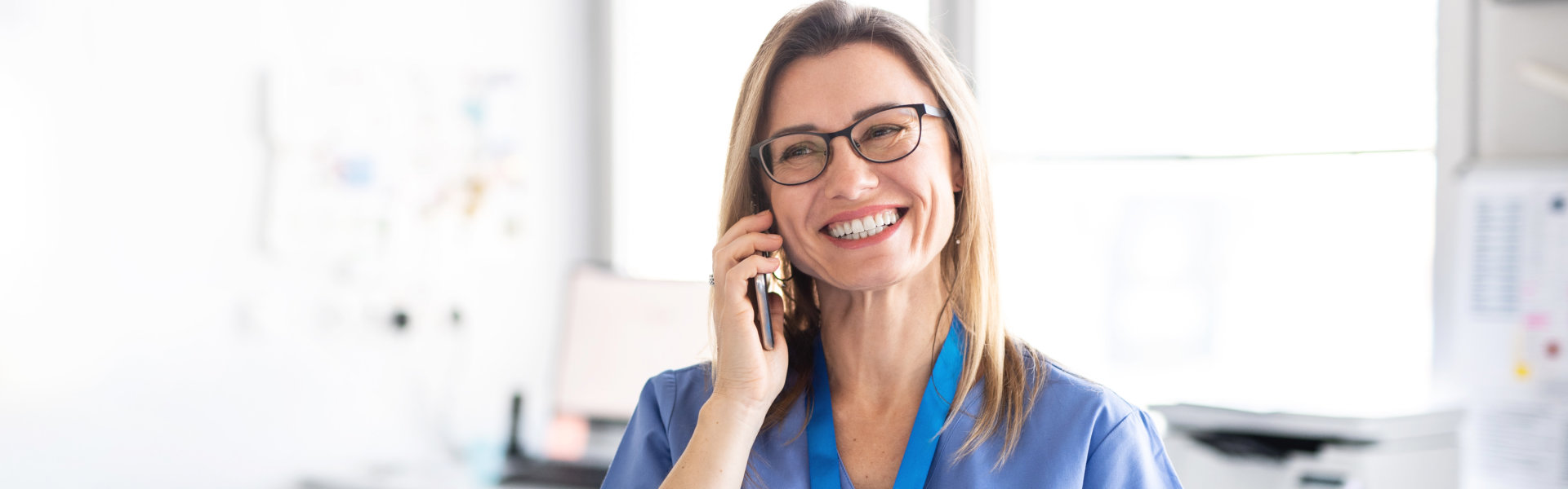 nurse smiling while calling with her phone